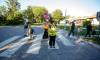 Nancy Fairbairn, a crossing guard since 2014, helps parents and their kids cross Waller Avenue as they head towards Ralph Maybank School Wednesday morning. (Mike Deal / Winnipeg Free Press)