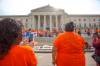 MIKE DEAL / WINNIPEG FREE PRESS Haven Stumpf a daughter of a residential school survivor wears an orange t-shirt with the words, “Reconciliation, Awareness, Residential Schools, Culture, Truth, Education, Solidarity, Unity, Respect,” written on the back, watches as singers perform on the steps of the legislative building. Members of the Fox Lake Cree Nation, York Factory First Nation and Tataskweyak Cree Nation — including leadership, residential school survivors and youth gather of the steps of the Manitoba Legislative building after walking from Winnipeg’s Victoria Inn at 1808 Wellington Ave. during the National Day for Truth and Reconciliation, on Thursday. 210930 - Thursday, September 30, 2021.