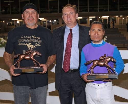 Jason Halstead / Assiniboia Downs
                                Assiniboia Downs CEO Darren Dunn (centre) presents 2022 leading trainer Jerry Gourneau and leading rider Jorge Carreno with their championship trophies.