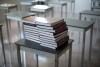 Books are piled onto a desk in a empty classroom. (Jonathan Hayward / The Canadian Press Files)