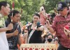 Nakuset, centre, executive director of the Native Women's Shelter of Montreal, holds a microphone for drummers during a gathering in Montreal, Thursday, July 1, 2021. The Indigenous advocate says a Montreal child and family services agency isn't serious about improving care for Indigenous youth and that the watchdog agency overseeing it lacks teeth. THE CANADIAN PRESS/Graham Hughes