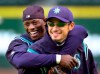FILE - Seattle Mariners' Mike Cameron, left, embraces teammate Ichiro Suzuki during their workout Monday, Oct. 8, 2001, in Seattle. An entire generation has waited for the Seattle Mariners to bring playoff baseball back to the Pacific Northwest. After a 21-year absence, the postseason is back in Seattle for Game 3 of the ALDS against Houston. (AP Photo/Elaine Thompson, File)
