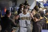 San Diego Padres starting pitcher Blake Snell is greeted by teammates after exiting during the sixth inning in Game 3 of a baseball NL Division Series against the Los Angeles Dodgers, Friday, Oct. 14, 2022, in San Diego. (AP Photo/Ashley Landis)