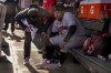 Cleveland Guardians Josh Naylor is checked by a trainer after scoring against the New York Yankees during the fourth inning of Game 2 of an American League Division baseball series, Friday, Oct. 14, 2022, in New York. (AP Photo/John Minchillo)