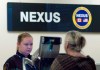 A Canada Border Services Agency officer speaks with a traveller at the Nexus office at the airport in Ottawa, Tuesday, May 8, 2012. THE CANADIAN PRESS/Adrian Wyld