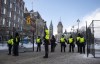 The Peace Tower is seen behind police at a gate along Queen Street as they restrict access to the streets around Parliament Hill in Ottawa, Saturday, Feb. 19, 2022. The inquiry into the federal government's use of the Emergencies Act during February's 