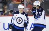 Winnipeg Jets forward Nikolaj Ehlers, left, celebrates his goal with teammate Adam Lowry during first period NHL pre-season hockey action against the Calgary Flames in Calgary, on Oct. 7, 2022. The Jets have placed Ehlers on injured reserve, retroactive to Tuesday. The winger will miss at least Saturday's visit from the Toronto Maple Leafs and Monday's tilt with the St. Louis Blues. THE CANADIAN PRESS/Jeff McIntosh