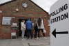 FILE - People queue at the entrance of a polling station in London, Thursday, May 6, 2021. Under Britain's parliamentary system, the public never actually votes for its prime minister. Instead, voters tick the box for a representative from their local area, who then becomes one of Britain’s 650 Members of Parliament. The party that wins a majority forms a government and puts their leader into the prime minister's seat. (AP Photo/Frank Augstein, File)