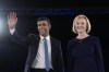 FILE - Liz Truss, right, and Rishi Sunak on stage after a Conservative leadership election hustings at Wembley Arena in London, Aug. 31, 2022. Rishi Sunak, the former British Treasury chief who won the race to be leader of the Conservative Party and is likely to become the country’s next prime minister, is getting cheers from an unlikely place: India, its former colony. Social media and TV channels in India are awash with comments and reactions to the accomplishment by the 42-year-old who has spoken publicly about his Indian roots and Hindu faith. (AP Photo/Kirsty Wigglesworth, File)