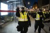 Police motion people to move back as they work to clear Rideau Street of vehicles during a demonstration in Ottawa, on Friday, April 29, 2022. THE CANADIAN PRESS/Justin Tang