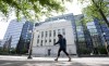 A woman walks past the Bank of Canada headquarters, Wednesday, June 1, 2022 in Ottawa. The Bank of Canada is expected to announce another hefty hike of its key interest rate on Wednesday morning, continuing one of the fastest monetary policy tightening cycles in its history, despite the growing warning signs of a potential recession. THE CANADIAN PRESS/Adrian Wyld