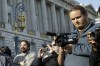 David DePape, right, records the nude wedding of Gypsy Taub outside City Hall on Dec. 19, 2013, in San Francisco. DePape is accused of breaking into House Speaker Nancy Pelosi's California home and severely beating her husband with a hammer. DePape was known in Berkeley, Calif., as a pro-nudity activist who had picketed naked at protests against local ordinances requiring people to be clothed in public. (AP Photo/Eric Risberg)