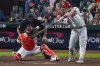 Philadelphia Phillies' J.T. Realmuto hits a home run during the 10th inning in Game 1 of baseball's World Series between the Houston Astros and the Philadelphia Phillies on Friday, Oct. 28, 2022, in Houston. (AP Photo/Sue Ogrocki)