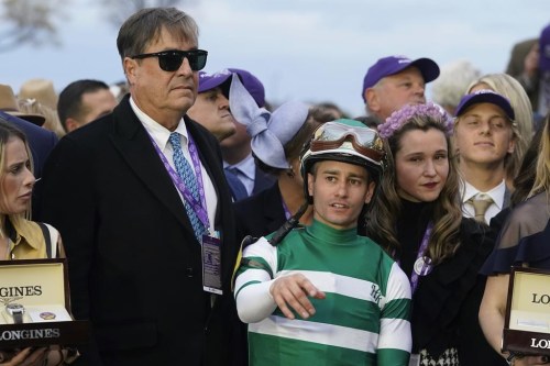 Trainer John W. Sadler stands next to jockey Flavien Prat after Flightline won the Breeders' Cup Classic horse race at Keenelend Race Course, Saturday, Nov. 5, 2022, in Lexington, Ky. (AP Photo/Darron Cummings)