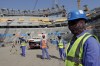 FILE - Laborers walk to the Lusail Stadium, one of the 2022 World Cup stadiums, in Lusail, Qatar, Friday, Dec. 20, 2019. With just days to go before Qatar hosts the World Cup, rights groups fear that a window for addressing the widespread exploitation of foreign workers could soon close. (AP Photo/Hassan Ammar, File)