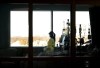 A registered nurse takes a moment to look outside while attending to a ventilated COVID-19 patient in the intensive care unit at the Humber River Hospital, in Toronto, Jan. 25, 2022. Canada's health ministers are set to meet in British Columbia this week, four months after premiers from across the country converged on Victoria to show a united front of frustration over what they called a 