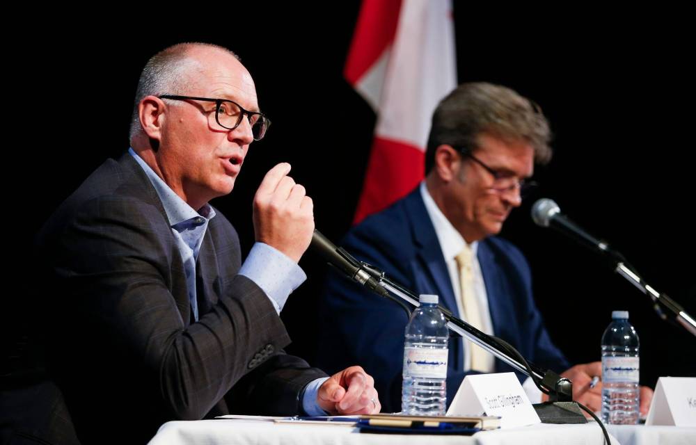 Scott Gillingham (left) and Kevin Klein took some shots at each other based on their time together as city councillors. (John Woods / Winnipeg Free Press)