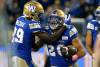 Winnipeg Blue Bombers&rsquo; Greg McCrae (29) and Brady Oliveira (20) celebrate Oliveira's touchdown against the Edmonton Elks during first half CFL action in Winnipeg Saturday, October 8, 2022. THE CANADIAN PRESS/John Woods