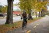 Sharee Hochman rides a bicycle on a trail alongside Assiniboine Avenue. (Jessica Lee / Winnipeg Free Press)