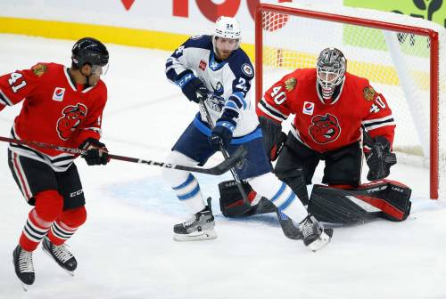 JOHN WOODS / WINNIPEG FREE PRESS
                                Manitoba Moose Jansen Harkins (24) deflects the puck at Rockford Icehogs goaltender Arvid Soderblom (40) as Isaak Phillips (41) defends during first period AHL action in Winnipeg on Sunday, October 16, 2022. Reporter: ?