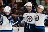 (AP Photo/Ross D. Franklin)
                                Winnipeg Jets right wing Blake Wheeler, middle, celebrates his game-winning goal against the Arizona Coyotes with Jets left wing Pierre-Luc Dubois (80) and Jets defenseman Neal Pionk, right, during overtime of an NHL hockey game at Mullett Arena in Tempe, Ariz., Friday, Oct. 28, 2022. The Jets won 3-2.