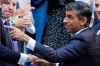 Rishi Sunak gestures as conservative MPs greet him after arriving at the Conservative Party leadership contest at the Conservative party Headquarters in London, Monday, Oct. 24, 2022. Rishi Sunak will become the next Prime Minister after winning the Conservative Party leadership contest.(AP Photo/Aberto Pezzali)