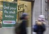 People walk pass a sign for flu shots in Toronto on January 9, 2018. Canada has entered a flu epidemic, the national public health agency said Tuesday, after the test positivity rate nearly doubled in one week. The Public Health Agency of Canada said in its FluWatch report that the rate jumped to 11.7 per cent the week of Oct. 30 to Nov. 5, compared to 6.3 per cent the previous week. The agency declared an epidemic, which happens most years after the threshold of a five per cent positivity rate is surpassed, though it said influenza levels are higher than would have been expected when compared to pre-pandemic years. THE CANADIAN PRESS/Doug Ives