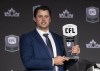 Most outstanding player, quarterback Zach Collaros of the Winnipeg Blue Bombers, holds up his trophy during the CFL Awards in Regina, Thursday, Nov. 17, 2022. THE CANADIAN PRESS/Paul Chiasson