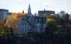 The Canadian prime ministers' residence, 24 Sussex, is seen on the banks of the Ottawa River in Ottawa on Monday, Oct. 26, 2015. The Parliament Hill Peace Tower is in the distance. THE CANADIAN PRESS/Sean Kilpatrick