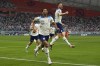 England's Jude Bellingham, centre, celebrates after scoring his side's opening goal during the World Cup group B soccer match between England and Iran at the Khalifa International Stadium in Doha, Qatar, Monday, Nov. 21, 2022. (AP Photo/Alessandra Tarantino)