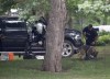 An RCMP officer works with a police dog as they move through the contents of a pickup truck on the grounds of Rideau Hall in Ottawa, Thursday, July 2, 2020. A Manitoba man who armed himself and rammed a gate at Rideau Hall to confront Prime Minister Justin Trudeau has been granted day parole after serving less than half his sentence. THE CANADIAN PRESS/Adrian Wyld