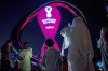 People take photos with the official FIFA World Cup Countdown Clock on Doha's corniche, in Qatar, Friday, Oct. 14, 2022. Carrie Serwetnyk, the first woman inducted into the Canadian Soccer Hall of Fame, is in Qatar for the 2022 World Cup and says the tournament is 