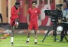 Canada forward Alphonso Davies, left, kicks the ball as teammate Tajon Buchanan, centre, watches during practice at the World Cup in Doha, Qatar, Tuesday, Nov. 22, 2022. THE CANADIAN PRESS/Nathan Denette