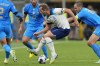 England's Harry Kane, center, wearing a rainbow armband, controls the ball during the UEFA Nations League soccer match between Italy and England at the San Siro stadium, in Milan, Italy, on September 23, 2022. Canadian members of Parliament passed a unanimous motion Tuesday condemning FIFA's decision to threaten on-field punishment if soccer players in the World Cup wear armbands supportive of the LGBTQ community. Some team captains planned to wear 