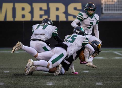 Dakota Lancer Brock Beauchemin holds on to the ball while being tackled by Vincent Massey's Brady Fay on Friday. (Jessica Lee / Winnipeg Free Press)