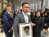 ERIK PINDERA / WINNIPEG FREE PRESS
                                Edward Balaquit holds a photograph of his father, Eduardo, outside Winnipeg’s courthouse on Wednesday, while his mother Illuminada stands to the right.