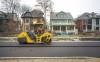 A road construction crew lays asphalt on Canora Street on Thursday. (Mike Deal / Winnipeg Free Press)