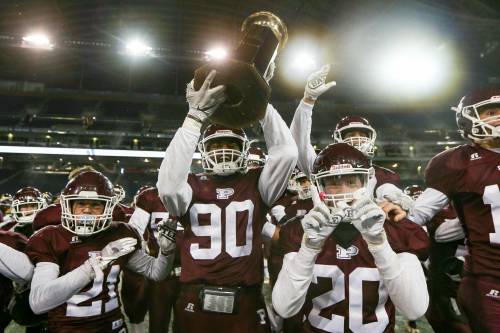 DANIEL CRUMP / WINNIPEG FREE PRESS
                                St. Paul’s Crusaders celebrate after defeating the Dakota Lancers in the high school varsity football final at IG Field on Saturday.