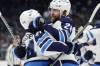 JOHN FROSCHAUER / THE ASSOCIATED PRESS
                                Winnipeg Jets defenseman Josh Morrissey (44), left, celebrates with right wing Blake Wheeler (26) after scoring the winning goal against the Seattle Kraken during overtime period of an NHL hockey game, Sunday in Seattle.