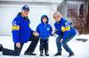 MIKAELA MACKENZIE / WINNIPEG FREE PRESS 
                                Brian and Pam Bachewich wear handknit sweaters made by Pam&rsquo;s mother in the 1970s, featuring the numbers of John Helton and Rick House, with their grandson Elliot McKie, age four, in a handmade Bombers jacket from the mid 1980s.