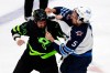 Dallas Stars left wing Jamie Benn and Winnipeg Jets defenceman Brenden Dillon fight on Feb 11, 2022. (AP Photo/Richard W. Rodriguez)