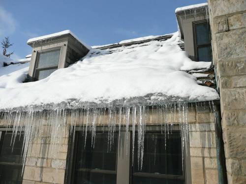 photo By Dmcroof / wikimedia commons
                                Ice damming not only creates dangerous, if pretty, icicles, it can also lead to water damage of the roof.