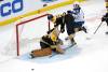 Boston goaltender Jeremy Swayman watches the puck after making a save as Jake DeBrusk crashes into the goal next to Jets&rsquo; center Cole Perfetti during the third period. (Mary Schwalm / The Associated Press)