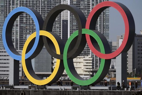 FILE - In this Dec. 1, 2020, file photo, the Olympic rings are reinstalled after it was taken down for maintenance ahead of the postponed Tokyo 2020 Olympics in the Odaiba section in Tokyo. The U.S. Olympic and Paralympic Committee is encouraging individual sports to consider “category qualifiers” — classified in some sports as “open” categories — to ensure transgender athletes will have events to participate in once they reach puberty. The USOPC finalized its two-page “position paper” at its board meeting earlier this month and released it Monday, Dec. 19, 2022, addressing a proposed path forward for transgender participation in sports. (AP Photo/Eugene Hoshiko, File)