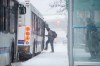 A man boards a bus at a bus stop along Portage Avenue in Winnipeg, Wednesday, April 13, 2022.THE CANADIAN PRESS/Mike Sudoma