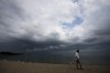 A person looks out over Lake Ontario as a thunderstorm rolls through Toronto on Thursday, August 4, 2022. THE CANADIAN PRESS/Nathan Denette