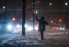 A person hails a taxi as heavy snow falls in downtown Vancouver, late Monday, Dec. 19, 2022. Weather warnings or special weather statements are posted in every province and territory except Manitoba as winter storms or extreme cold usher in the official start of winter. THE CANADIAN PRESS/Darryl Dyck