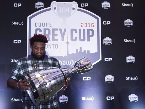 Calgary Stampeders offensive lineman Derek Dennis touches the Grey Cup ahead of the 104th CFL Grey Cup against the Ottawa Redblacks in Toronto on Thursday, November 24, 2016. For veteran CFL lineman Dennis, Damar Hamlin's horrific injury is another sober reminder of the potential perils of professional football. Hamlin, a defensive back with the Buffalo Bills, remains in critical condition in a Cincinnati hospital after suffering cardiac arrest on the field in the first quarter of Monday night's game versus the Bengals. THE CANADIAN PRESS/Nathan Denette