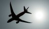 A plane is silhouetted as it takes off from Vancouver International Airport in Richmond, B.C., Monday, May 13, 2019. New Democrat Leader Jagmeet Singh says he wants to see more competition within Canada's airspace in order to make flying more affordable for people.THE CANADIAN PRESS/Jonathan Hayward