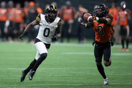 B.C. Lions defensive back Loucheiz Purifoy, right, nearly makes an interception on a pass intended for Hamilton Tiger-Cats' Bralon Addison during the second half of CFL football game in Vancouver, on Thursday, July 21, 2022. The Lions released Purifoy on Wednesday. THE CANADIAN PRESS/Darryl Dyck